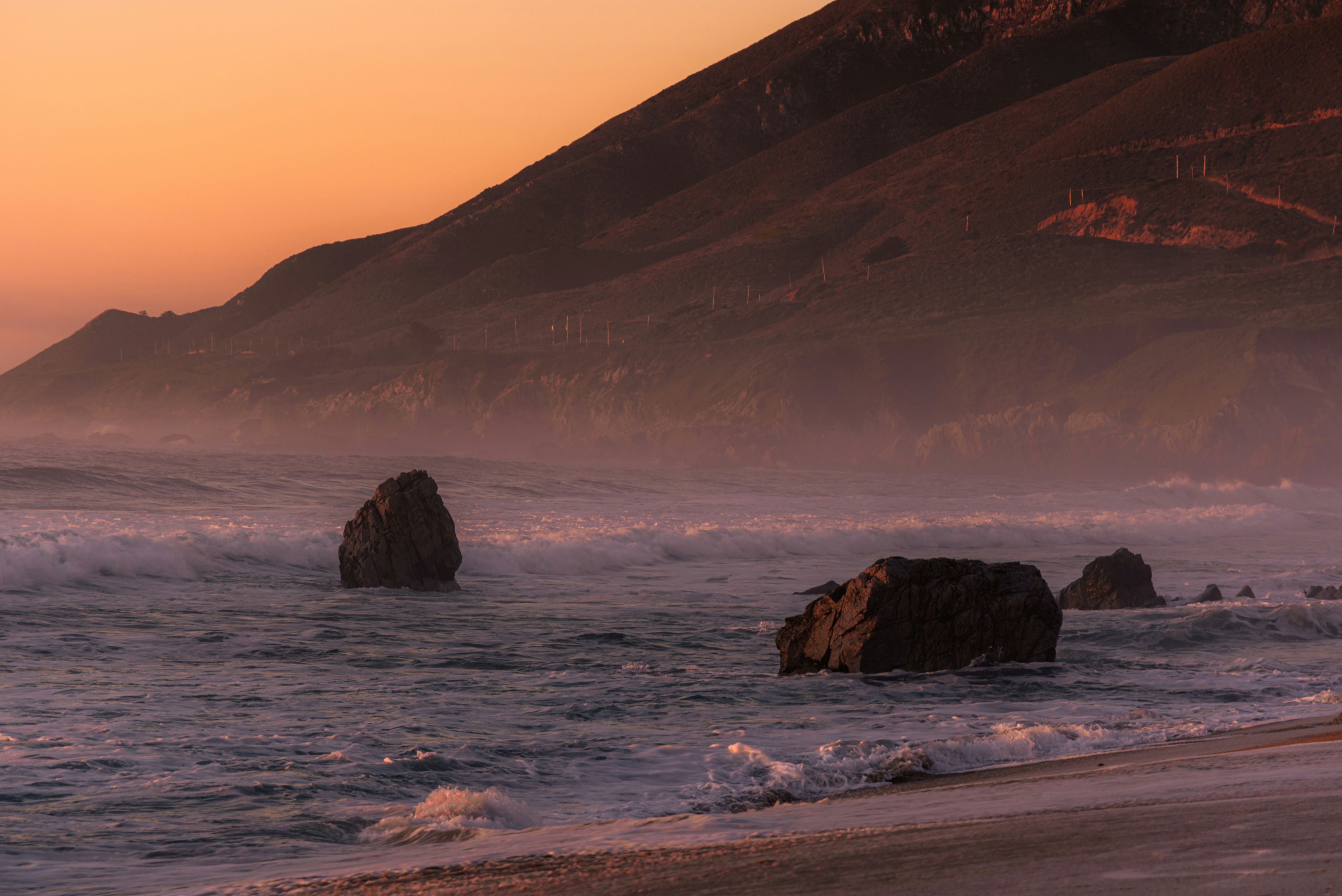 a beach with waves crashing on the shore